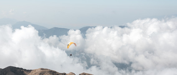 A paraglider is silhouette on the background of the beautiful Taurus Mountains near Kemer, Antalya,...
