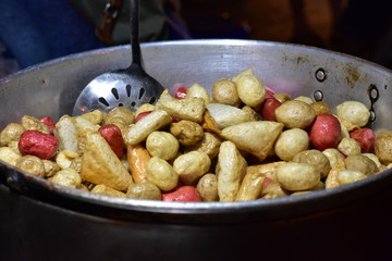 Total meatballs fried in a large pan.