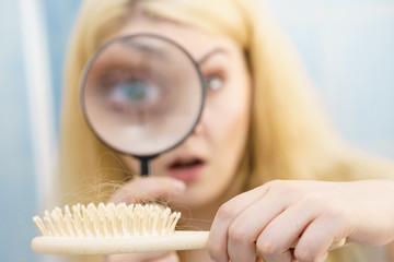 Woman magnifying hair brush