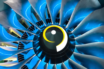 Turbo jet engine blades of the aircraft, close up in the blue light from the inside.