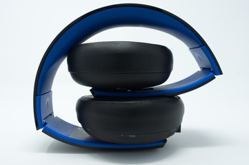 Black and blue folded over the ear headphones.