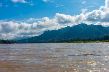 Beautiful green hills landscape and rivers on blue sky background. decoration image contain certain grain noise and soft focus.