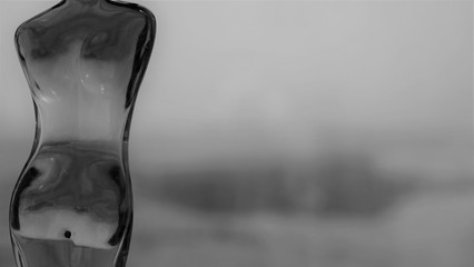 black and white picture of glass bottle in form of young woman body