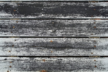 Beach boardwalk. Wood texture. After rain, worn white paint.