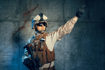 Fototapeta premium Special forces United States soldier or private military contractor holding rifle. Image on a dark background