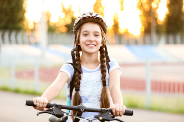 Cute girl riding bicycle outdoors © Pixel-Shot
