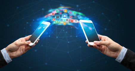 Two mobile phones syncing applications concept
