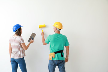 Happy young couple doing repair in their new house