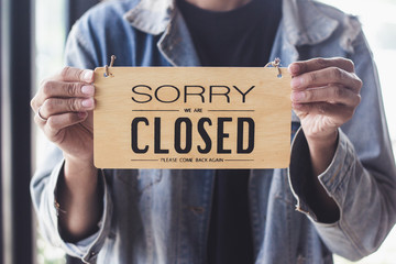 Close up sign hanging off Coffee shop door,Close sign blur background,Label word close