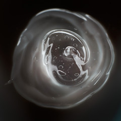 Cream gel transparent cosmetic sample texture with bubbles isolated on black background. Cosmetic...