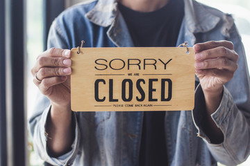 Close up sign hanging off Coffee shop door,Close sign blur background,Label word close