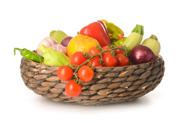 Many healthy vegetables and fruits in basket on white background
