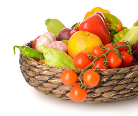 Many healthy vegetables and fruits in basket on white background