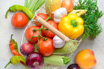 Basket with many healthy vegetables on grey background