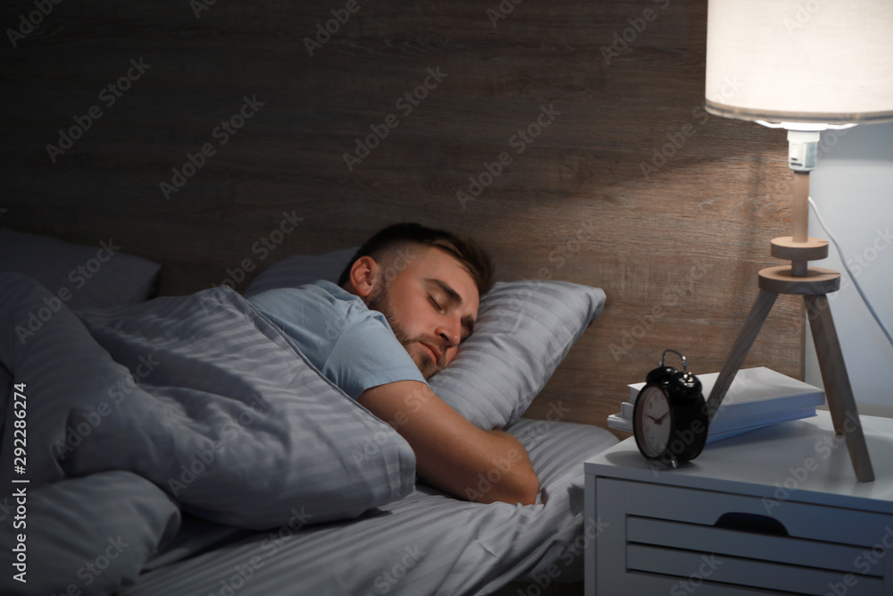 Canvas Prints young man sleeping in bed at night