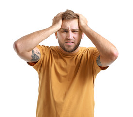 Young man suffering from headache on white background