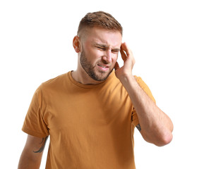 Young man suffering from headache on white background