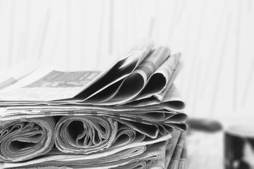 Big Pile of Newspapers on Wooden Table. Magazines and Journals Stacked in Heap. News Pages with...