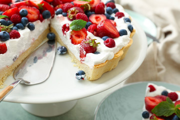 Stand with tasty berry pie on table, closeup