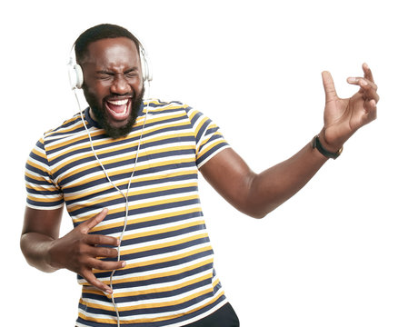 Happy African-American Man Listening To Music On White Background