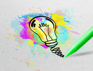 Drawing colorful bulb and multimedia symbols on white paper