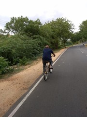 old man riding cycle in Hampi