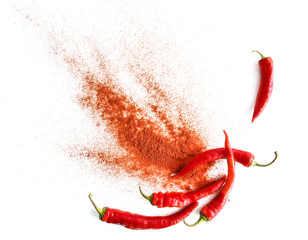 Red chili peppers and powder on white background