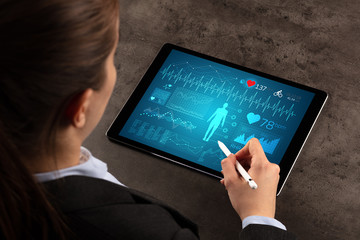 Business woman making healthy analysis on tablet