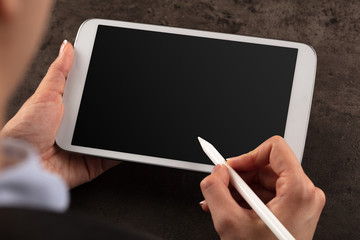 Business woman working on empty tablet with pencil
