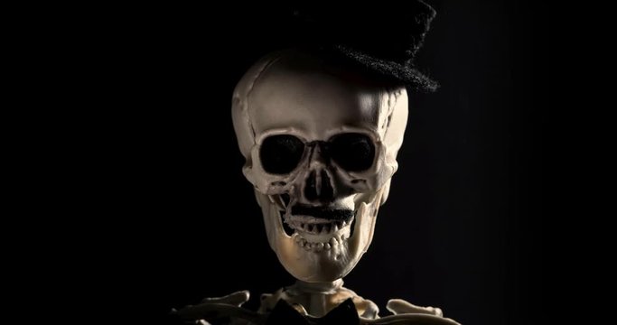 Speaking Skeleton with a hat and mustache on a black background. Stop Motion footage.