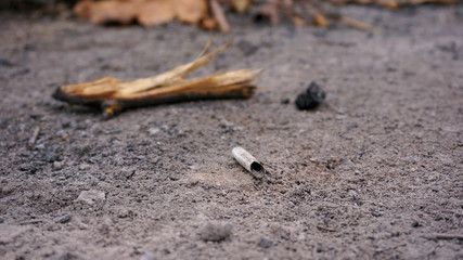 cigarette butt in the ashes