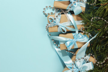 Gift boxes wrapped in craft paper with blue satin ribbons	