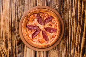 Delicious pizza with meat, cheese and mushrooms	