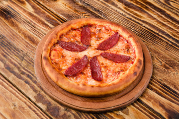 Delicious pizza with meat, cheese and mushrooms	