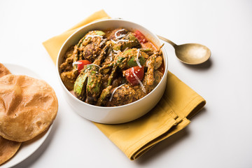 Undhiyu is a Gujarati mixed vegetable dish, specialty of Surat, India. Served in a bowl with or without poori