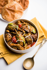 Undhiyu is a Gujarati mixed vegetable dish, specialty of Surat, India. Served in a bowl with or without poori
