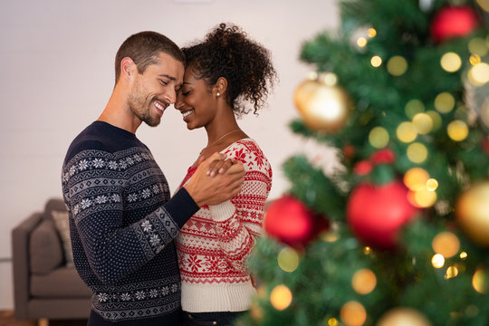 Multiethnic couple in love dancing during christmas
