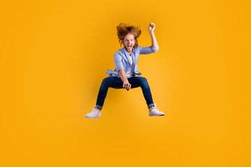 Fototapeta na wymiar Full length body size photo of cheerful crazy excited horse rider wearing jeans denim checkered blue shirt approaching jumping isolated over vivid color background