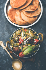 Undhiyu is a Gujarati mixed vegetable dish, specialty of Surat, India. Served in a bowl with or without poori