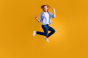 Fototapeta na wymiar Full length body size photo of crazy excited trendy stylish white guy shouting while greeting you by showing v-sign wearing sneakers jeans denim blue checkered shirt isolated vivid color background