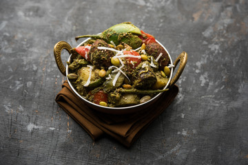 Undhiyu is a Gujarati mixed vegetable dish, specialty of Surat, India. Served in a bowl with or without poori