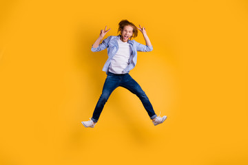 Fototapeta na wymiar Full length body size photo of shouting crazy ecstatic overjoyed guy jumping up wearing jeans denim sneakers isolated over bright color background showing you v-sign