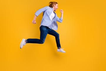 Full length body size photo of cheerful handsome crazy ecstatic guy running towards his dream wearing sneakers denim blue shirt isolated over vibrant color background