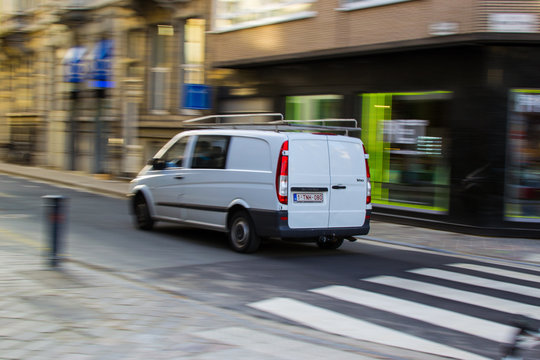 Ghent, Belgium; 10/31/2018: Panning effect photography of a white furgo through a street in the city