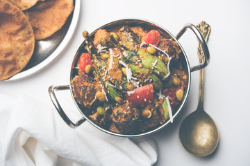 Undhiyu is a Gujarati mixed vegetable dish, specialty of Surat, India. Served in a bowl with or without poori