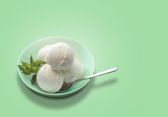 Balls of fresh ice cream with a sprig of mint.