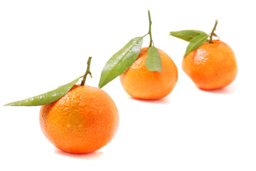 Mandarin with green leaf isolated on white background.