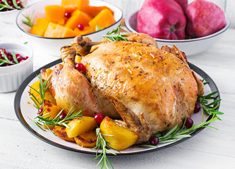 Roasted turkey garnished with cranberries on a rustic style table decorated  autumn leaf. Thanksgiving Day. Baked chicken.