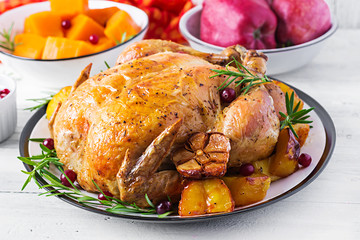 Roasted turkey garnished with cranberries on a rustic style table decorated  autumn leaf. Thanksgiving Day. Baked chicken.