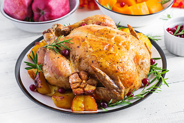 Roasted turkey garnished with cranberries on a rustic style table decorated  autumn leaf. Thanksgiving Day. Baked chicken.